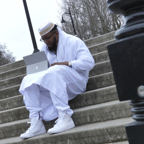 Man sitting on steps with laptop